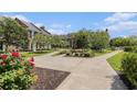 Beautiful courtyard featuring benches surrounded by lush landscaping and brick-paved walkways at 750 Howard Ave. # E, Myrtle Beach, SC 29577
