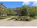 Peaceful courtyard featuring benches surrounded by lush landscaping and brick-paved walkways at 750 Howard Ave. # E, Myrtle Beach, SC 29577
