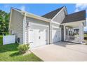 Dual garages adjacent to house and next to covered porch offering ample parking and side yard at 775 Harrison Mill St., Myrtle Beach, SC 29579