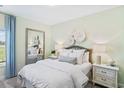 Serene bedroom with soft green walls, plush bedding, and a large mirror, creating a tranquil retreat at 866 Fowler Rd., Conway, SC 29526