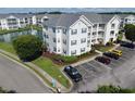 An aerial view of the condo community with a lake and landscaping showcasing the surrounding area at 901 West Port Dr. # 305, North Myrtle Beach, SC 29582