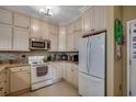 The kitchen has white cabinets, stainless steel appliances, and a tile backsplash at 901 West Port Dr. # 305, North Myrtle Beach, SC 29582