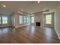 Spacious living room featuring recessed lighting, wood floors, fireplace, and a wall of windows overlooking lake at 924 Lady Bird Way, North Myrtle Beach, SC 29582