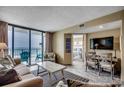 Relaxing living room with balcony offering stunning ocean views and beach access at 9400 Shore Dr. # 617, Myrtle Beach, SC 29572