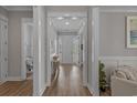 Bright hallway with wood floors leading to various rooms in the home at 945 Waterbridge Blvd., Myrtle Beach, SC 29579
