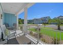 Relaxing front porch with rocking chairs and a view of the neighborhood at 945 Waterbridge Blvd., Myrtle Beach, SC 29579