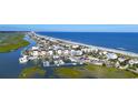 Breathtaking aerial view of a coastal community featuring a marina and stunning oceanfront residences at 9734 Indigo Creek Blvd., Murrells Inlet, SC 29576