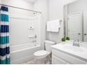 Bright bathroom featuring a shower-tub combo, white cabinets, and modern fixtures at 9734 Indigo Creek Blvd., Murrells Inlet, SC 29576