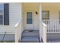 Inviting front porch featuring a white front door with a storm door, fresh paint, and a welcome mat at 10071 Kings Rd., Myrtle Beach, SC 29572
