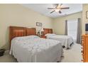 Cozy bedroom with two beds, complemented by a ceiling fan and natural light from a window at 1009 World Tour Blvd. # 105, Myrtle Beach, SC 29579
