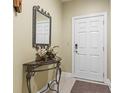 Foyer featuring decorative table with mirror and elegant floral arrangement, next to the unit door at 1009 World Tour Blvd. # 105, Myrtle Beach, SC 29579