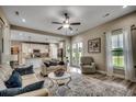 Bright living room with hardwood floors, ceiling fan, and an open layout with easy access to the kitchen at 101 Karlie Ln., Aynor, SC 29511