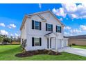 Charming two-story home with black shutters and a two-car garage at 1025 Kinness Dr., Conway, SC 29527
