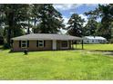 Inviting single-story home with a well-maintained lawn, mature trees, and brick facade at 109 S Maple Ave., Andrews, SC 29510