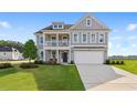 Inviting two-story home with a quaint front porch and lush green lawn at 1106 Laconic Dr., Myrtle Beach, SC 29588