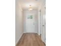Welcoming entryway showcasing a bright white door and wood-look flooring at 1107 Woodside Dr., Conway, SC 29526