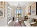 Bright foyer featuring hardwood floors, white trim, and french doors leading to another room at 1114 Laconic Dr., Myrtle Beach, SC 29588