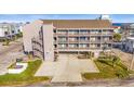 An exterior view of the condo building with exterior stairwell access on all levels for ease of access at 120 Dogwood Dr. N # 313, Garden City Beach, SC 29576