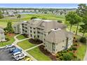 Aerial view showcasing the attractive low-rise condos, landscaping, and ample parking in a golf course community at 1401 Lighthouse Dr. # 4334, Little River, SC 29566