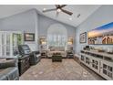 Bright living room featuring vaulted ceiling, plush seating, and an abundance of natural light at 1413 Cottage Cove Circle, North Myrtle Beach, SC 29582