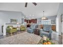Inviting living area with vaulted ceilings, a ceiling fan, hardwood floors, and open to the kitchen at 1413 Cottage Cove Circle, North Myrtle Beach, SC 29582