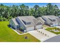 Inviting home with well-maintained landscaping, a spacious front yard, and an attached two-car garage at 1520 Jardine Loop, Little River, SC 29566