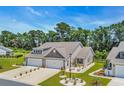 Beautiful home showcasing lush landscaping and a two-car garage, perfect curb appeal at 1520 Jardine Loop, Little River, SC 29566