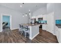 Bright kitchen featuring a central island with seating and stainless steel appliances at 1520 Jardine Loop, Little River, SC 29566