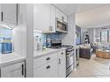 Well-lit kitchen boasts marble counters, blue backsplash, stainless steel appliances, and convenient access to living room at 2001 S Ocean Blvd. # 1408, Myrtle Beach, SC 29577