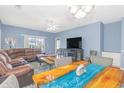 Spacious living area with a cozy sectional, modern coffee table, and ample natural light at 2060 Cross Gate Blvd. # 102, Surfside Beach, SC 29575