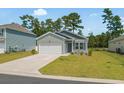 Charming one-story home with attached garage, well-manicured lawn, and lovely landscaping at 228 Averyville Dr., Conway, SC 29526