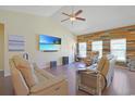 Bright living room featuring hardwood floors, vaulted ceilings, and a statement wood accent wall at 232 Angel Wing Dr., Myrtle Beach, SC 29588