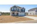 Charming two-story home featuring a gray exterior, two-car garage, and a well-manicured lawn at 28 Cape Point Dr., Conway, SC 29527