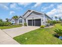 This home features a well-manicured lawn, landscaping and a two-car garage at 2882 Ophelia Way, Myrtle Beach, SC 29577