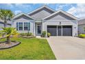 This home features lovely landscaping, a well-manicured lawn and a two-car garage at 2882 Ophelia Way, Myrtle Beach, SC 29577