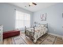 Serene bedroom with a metal bed frame, wood floors, and soft natural light at 308 Firenze Loop, Myrtle Beach, SC 29579