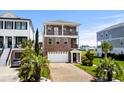 A two-story brick home showcasing an attached two-car garage and manicured landscaping at 337 St. Julian Ln., Myrtle Beach, SC 29579