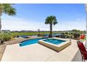 An in-ground pool and attached hot tub, ideal for outdoor relaxation and entertaining friends at 337 St. Julian Ln., Myrtle Beach, SC 29579
