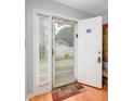 Bright entryway with a storm door, laminate flooring, and view of the parking area at 3700 Golf Colony Lane # 26A, Little River, SC 29566