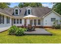 Spacious backyard deck with an umbrella table setup, perfect for outdoor entertaining and relaxation at 3772 Brown Bark Ln., Murrells Inlet, SC 29576