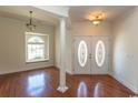 Elegant foyer with hardwood floors, decorative lighting, front door with decorative glass, and large window at 413 Sea Vista Ln., North Myrtle Beach, SC 29582