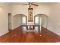 Bright living room with hardwood floors, arched doorways, fireplace, and decorative hanging at 413 Sea Vista Ln., North Myrtle Beach, SC 29582