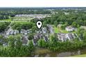 Aerial view of a condo complex with mature trees, lush landscaping and proximity to nearby amenities at 4344 Spa Dr. # 605, Little River, SC 29566