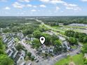 A birds-eye view shows a complex with well-kept landscaping, tree coverage, and convenient access to nearby roadways at 4344 Spa Dr. # 605, Little River, SC 29566