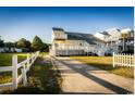 Exterior view featuring a long driveway and a well-manicured lawn at 4806 S Ocean Blvd., Surfside Beach, SC 29575