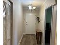 The condo's entrance features a light fixture, wood-look flooring, and a closet for storage at 5001 Little River Rd. # W101, Myrtle Beach, SC 29577