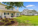 Outdoor patio with furniture set, overlooking a spacious lawn and neighboring properties at 503 20Th Ave. N # 29-C, North Myrtle Beach, SC 29582