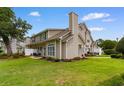 Expansive backyard featuring a well-maintained lawn and a patio area perfect for outdoor dining at 503 20Th Ave. N # 29-C, North Myrtle Beach, SC 29582