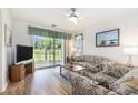 Comfortable living room with ceiling fan, sliding glass doors to the patio, and a view of the pond at 537 White River Dr. # 17C, Myrtle Beach, SC 29579