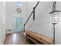 Inviting foyer with a wooden bench, staircase, and stylish light fixture at 540 Chanted Dr., Murrells Inlet, SC 29576